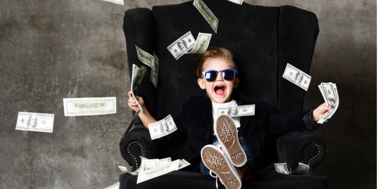 Rich kid throwing money
