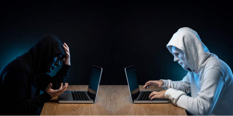 Hackers sitting with masks to each other