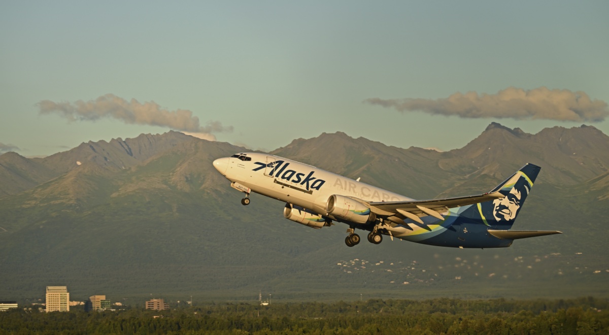 white plane taking off, blue tail with white face, Alaska air craft