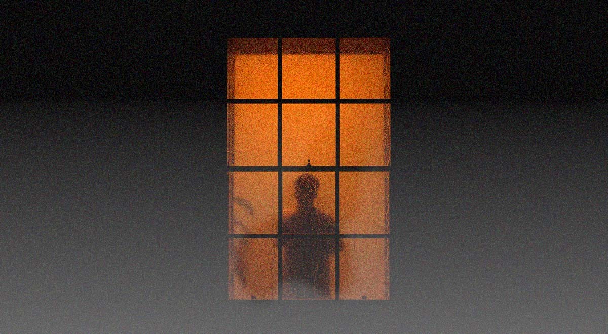 A dark silhouette through an orange window.