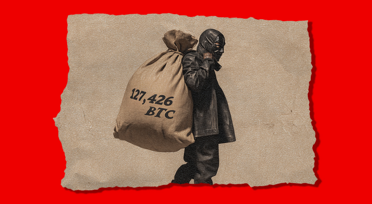 man n leather black mask carries a brown sack, black throusers, red background