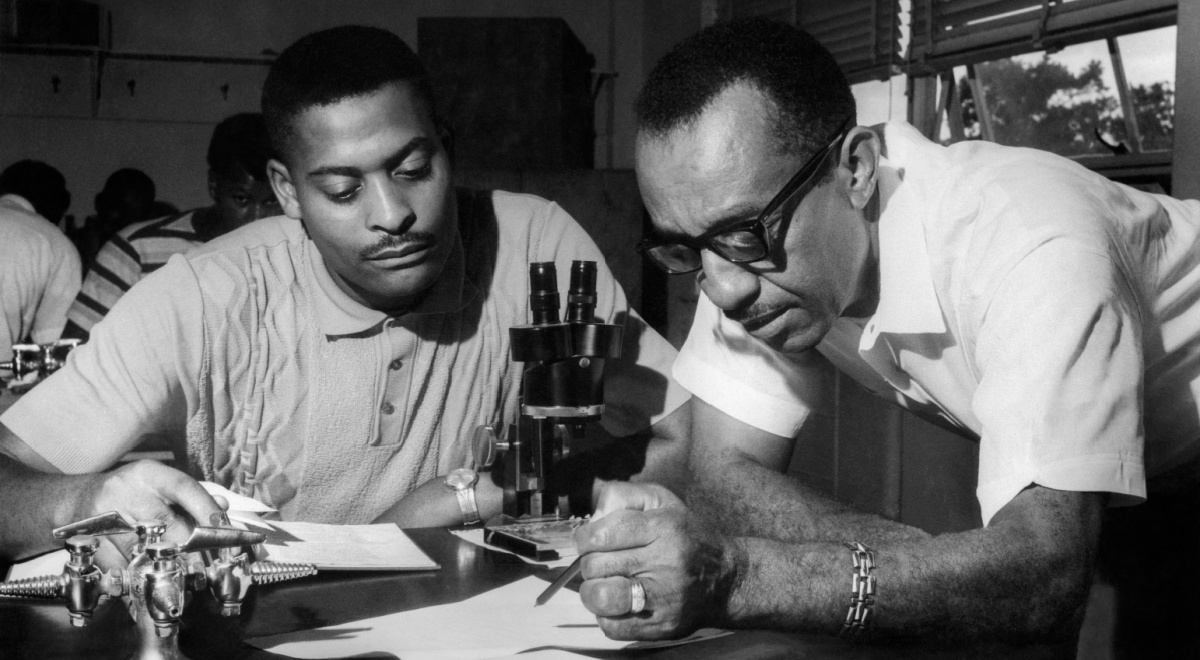 A black and white photo of professors in the lab.