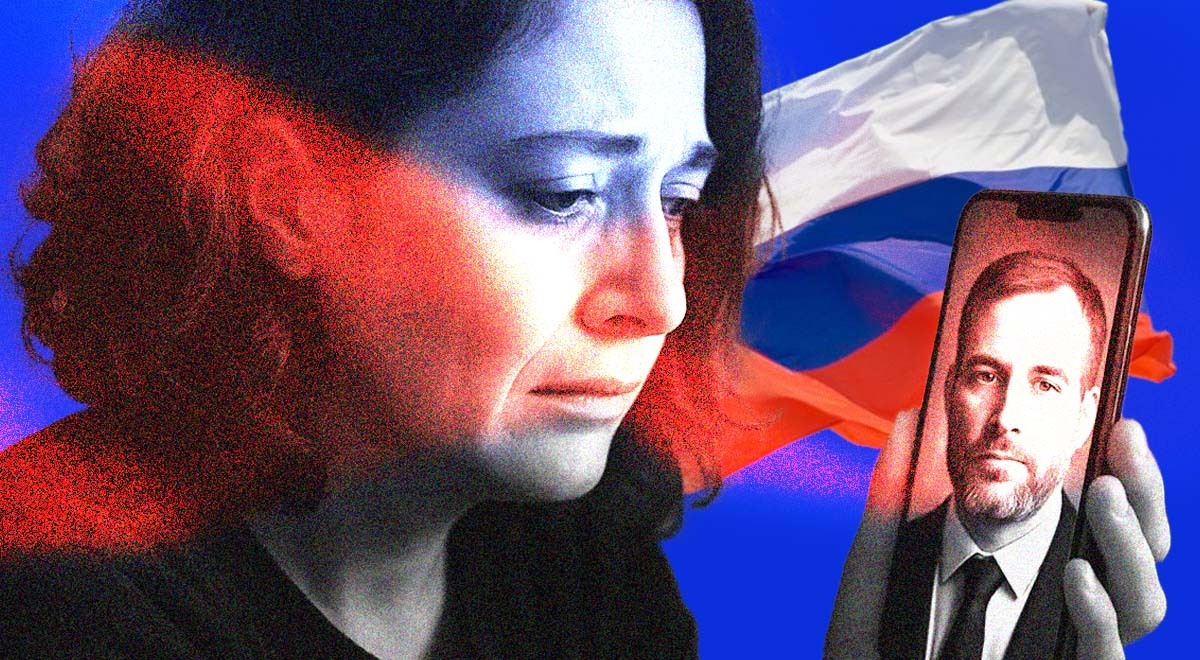A Russian widow gazing at her deceased soldier husband, with the Russian flag in the background.