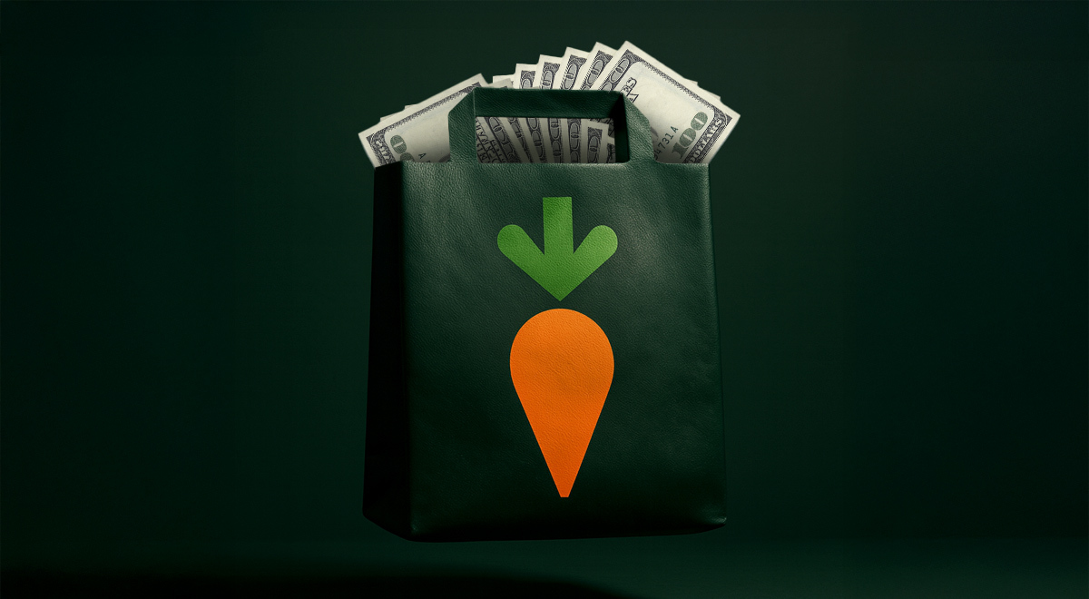 A black bag full of money with an image of a carrot on it