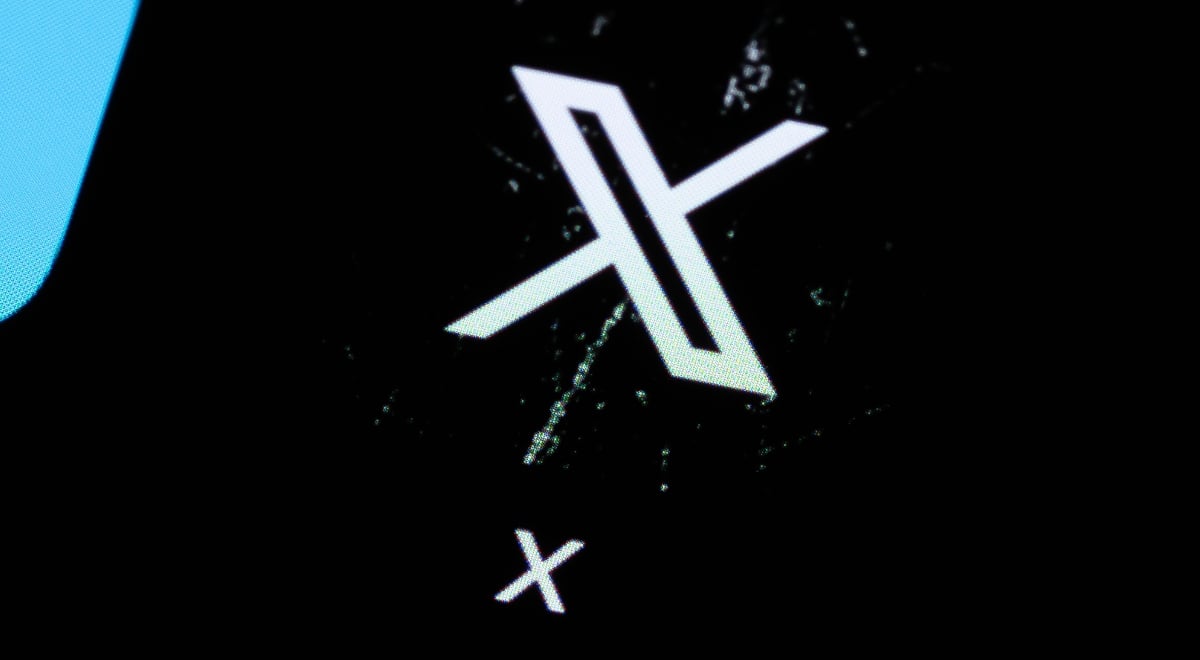 X app logo on phone screen, scratched