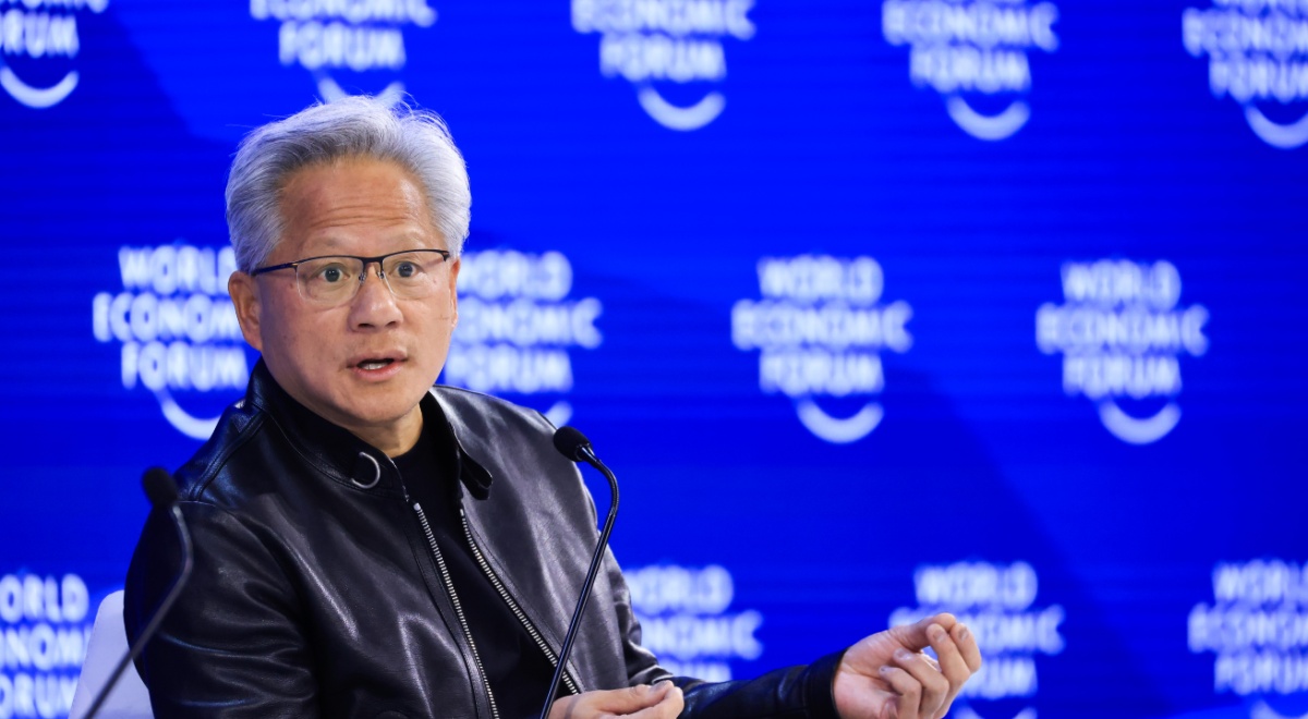 Jensen Huang, grey hair, black leather jacket, blur photo wall, world economic forum