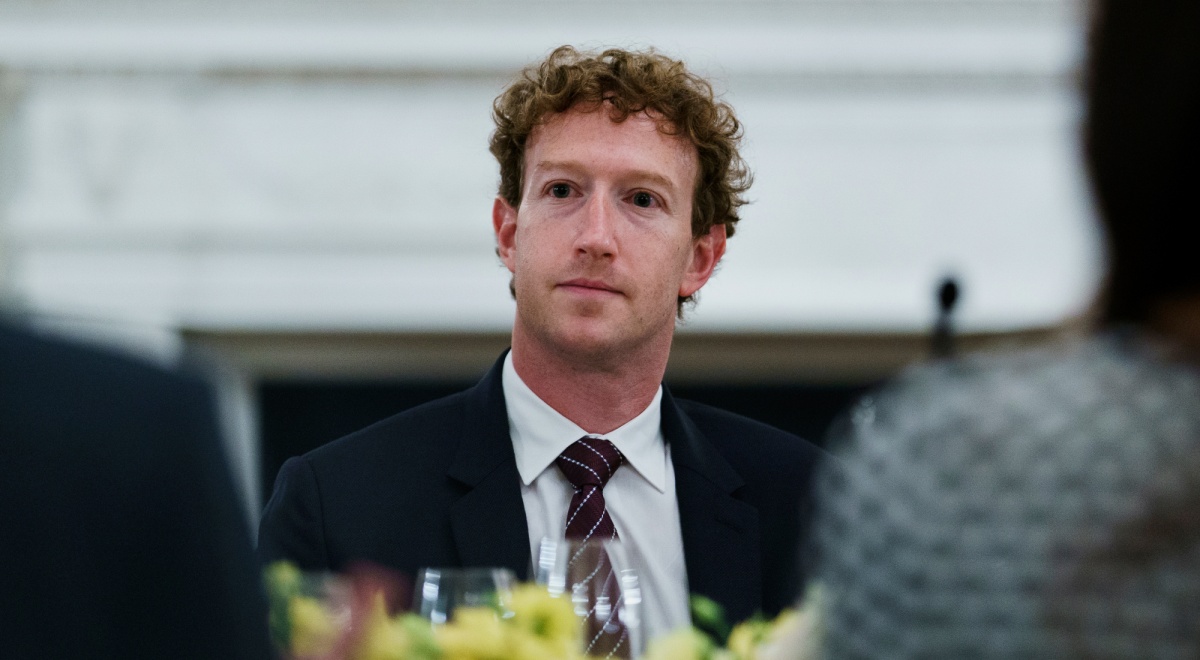 Mark Zuckerberg at dinner table, black tie, pale skin, white shirt, black eyes, curly hair
