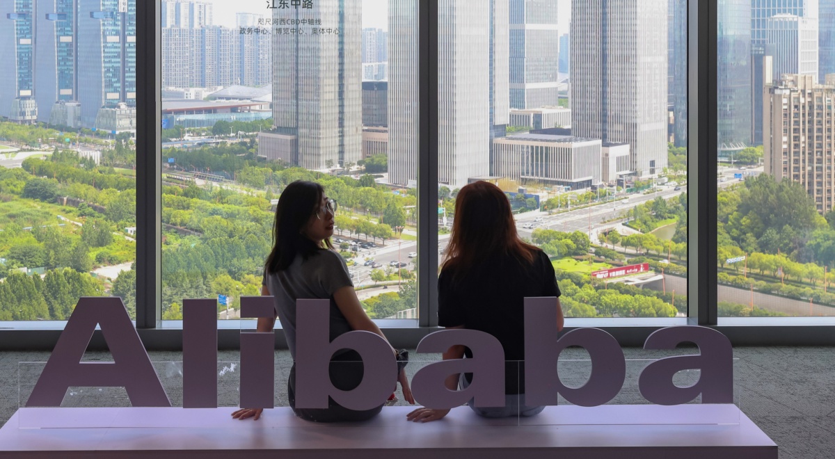 alibaba_White Alibaba logo, 4 big windows, city park, big buildings, two asian girls
