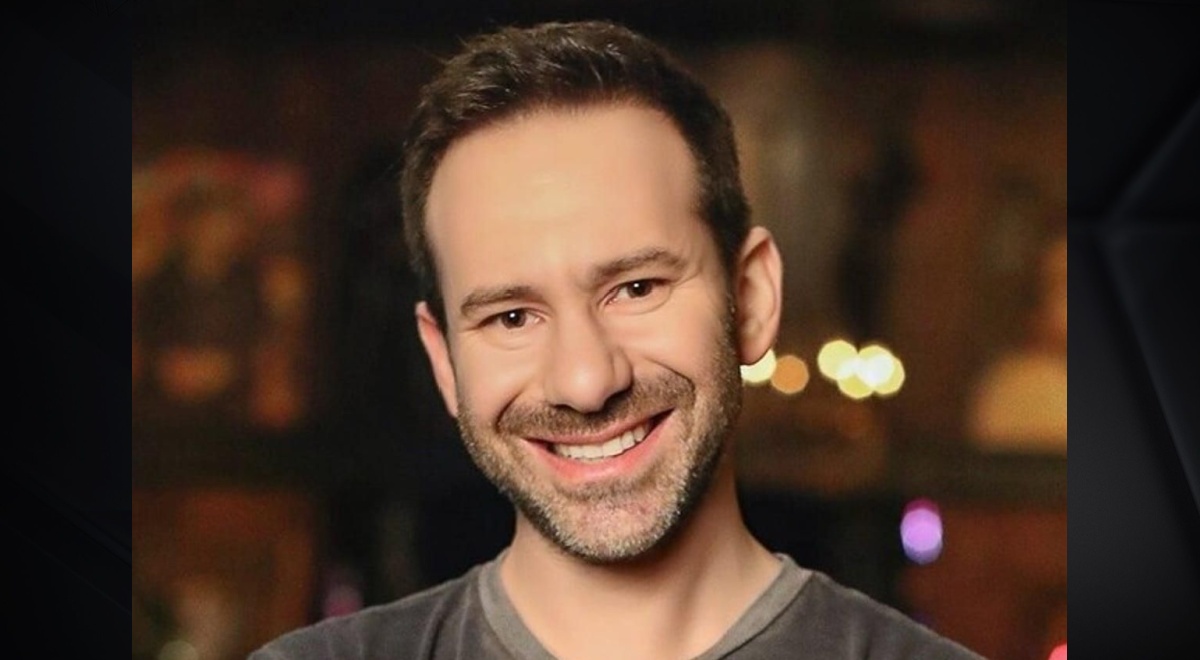 OnlyFans owner Leonid Radvinsky in grey shirt, smilind, black short beard, dark eyes, white teeth