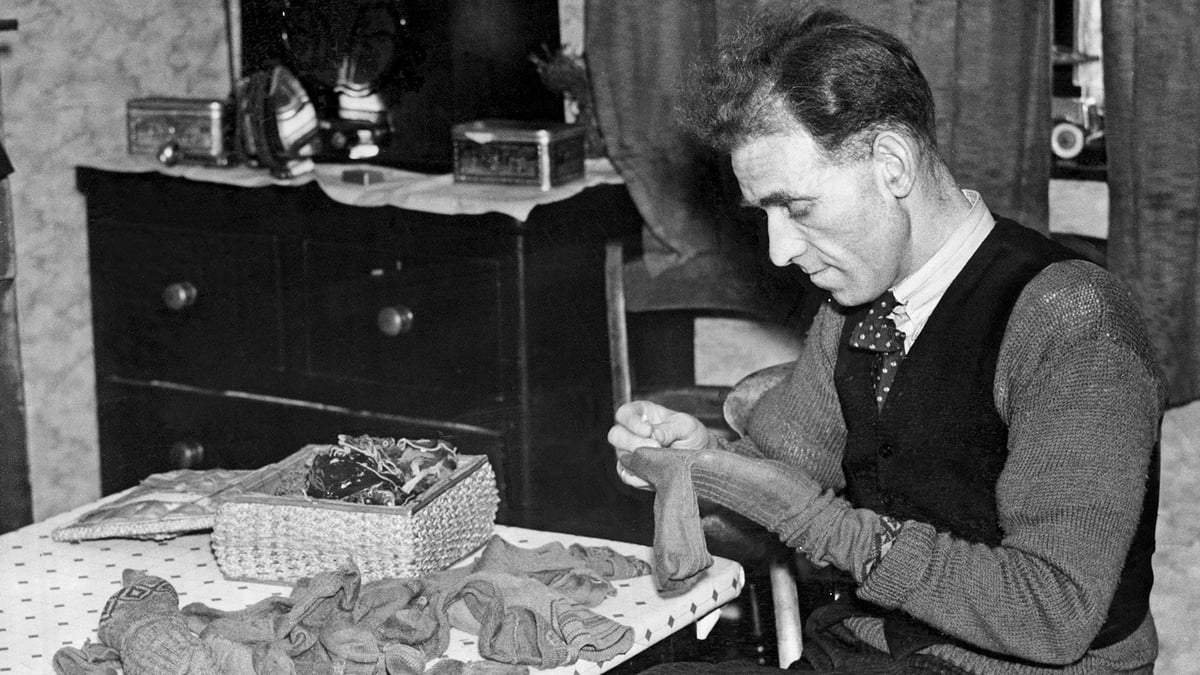 man darning socks 1937 getty images