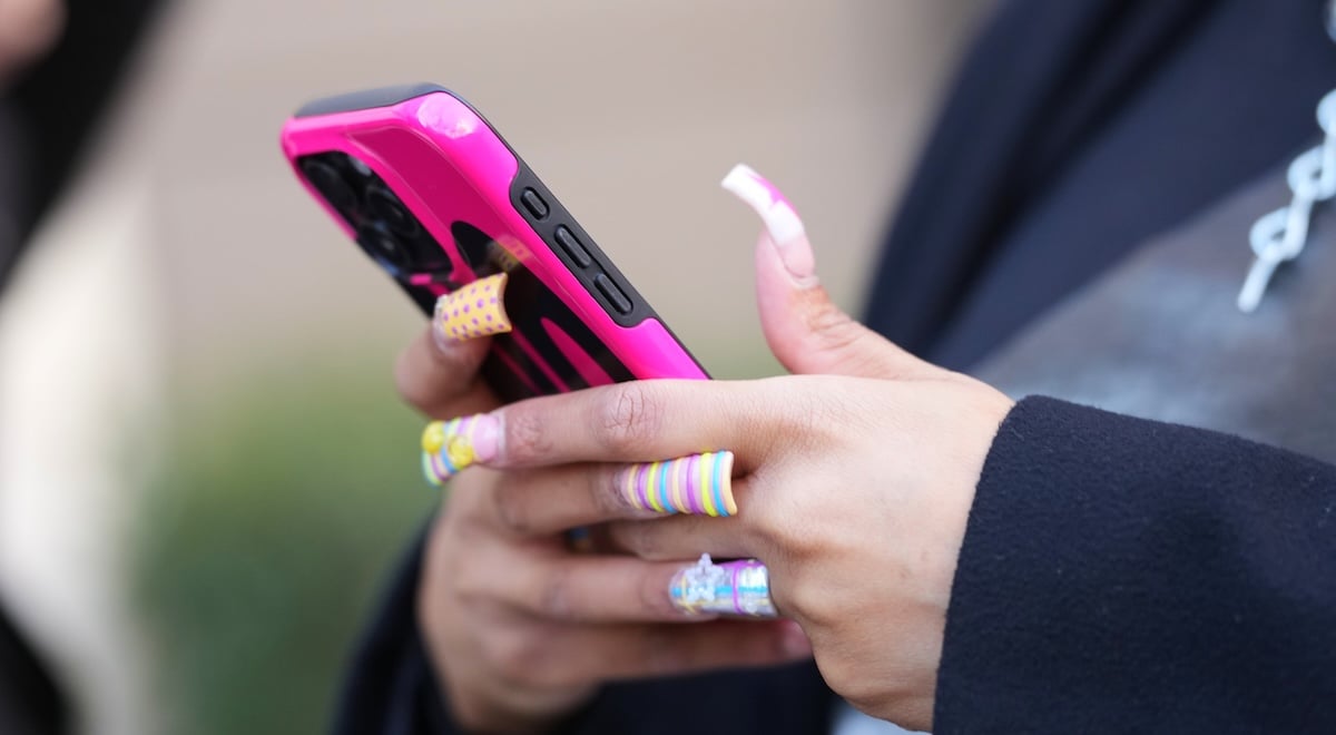 phone user with long nails