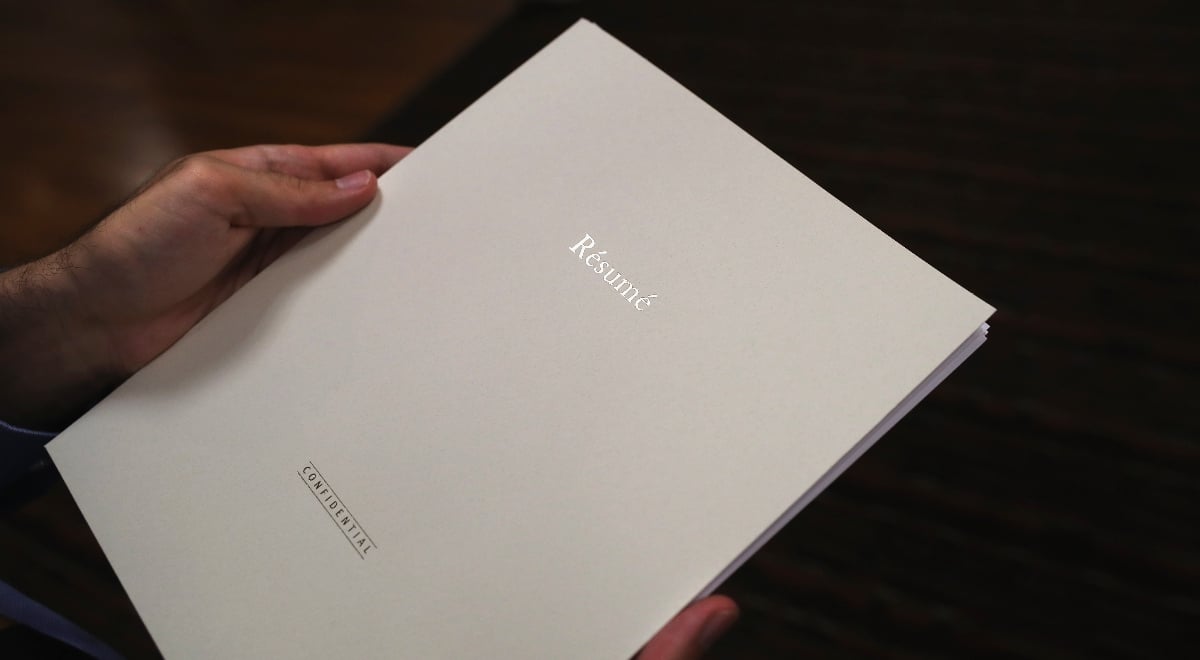 Resume with tag "confidential" in person's hands; CV; fake resumes; HR
