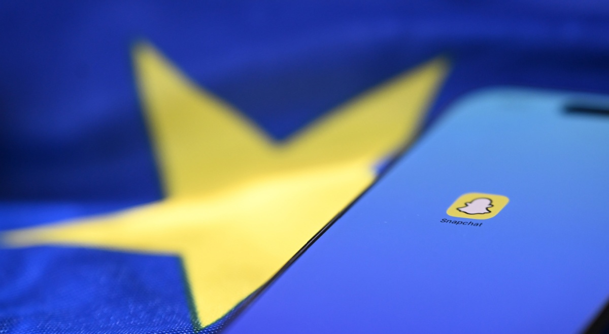 snapchat icon on phone with blue screen, eu flag, yellow star