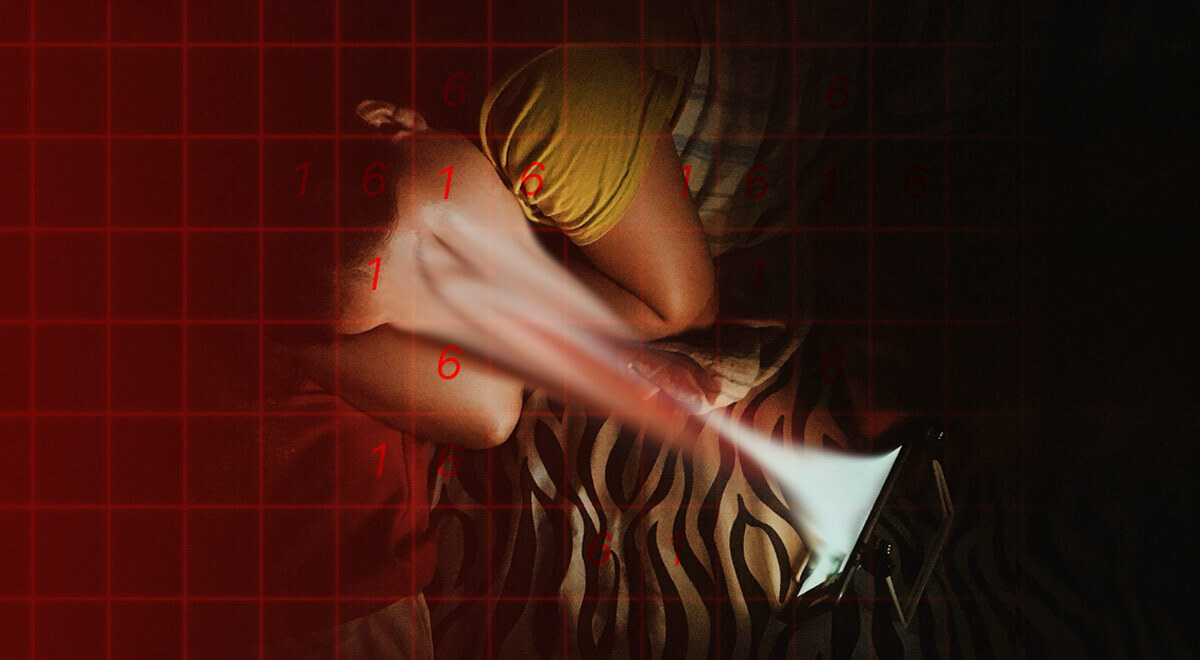 a teenage kid lies on left side in bed, face sucked in to his glowing smartphone screen.