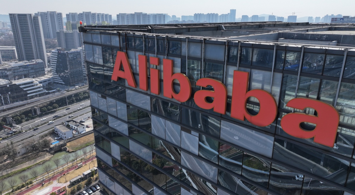 alibaba orange logo on top of dark glass building