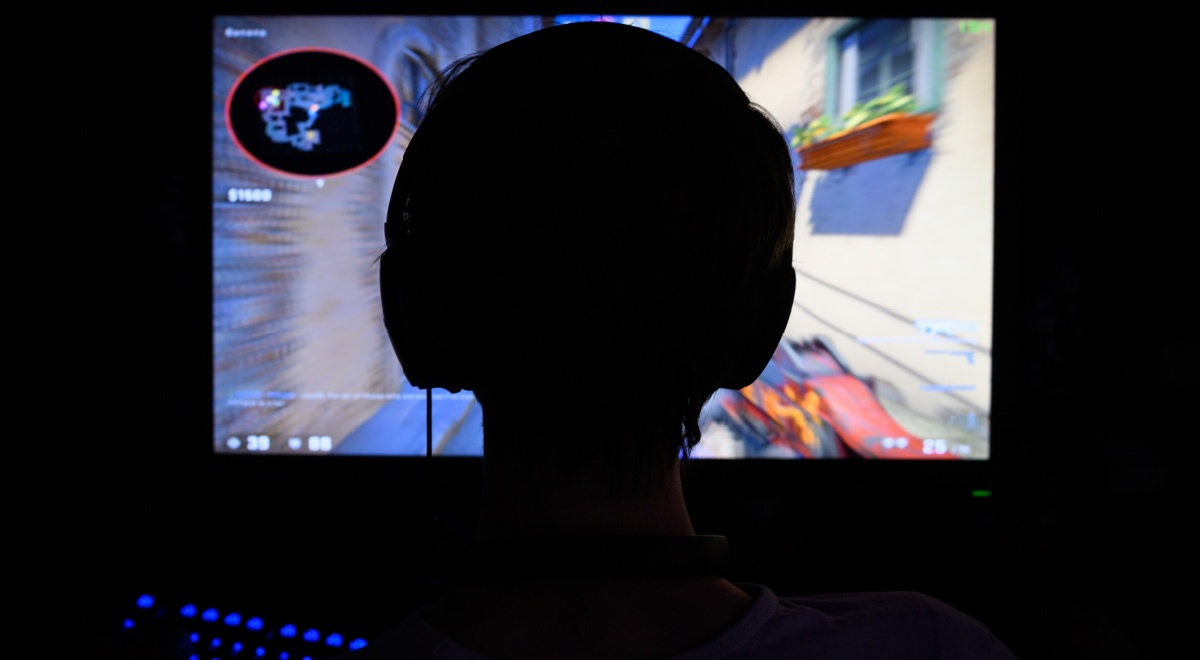 A counterstrike gamer playing in the dark.