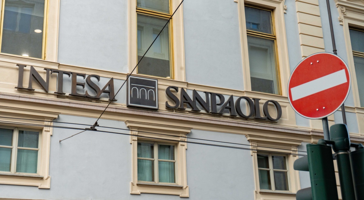 intensa sanpaolo sing over green windows, wall exterior, red stop sign