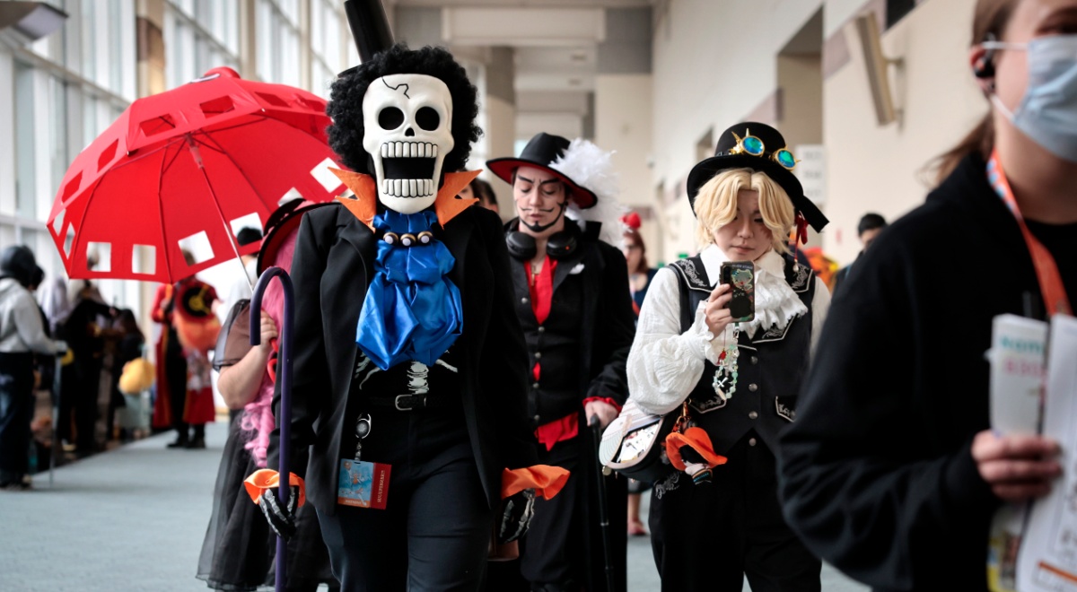 cosplayer, Brook from One Piece costume, white broken scull, red umbrella, shiny blue blouse
