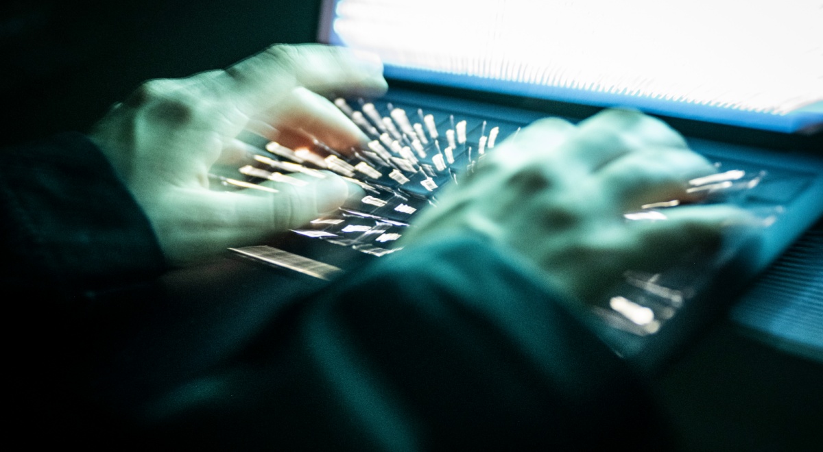 Hands on a keyboard typing.