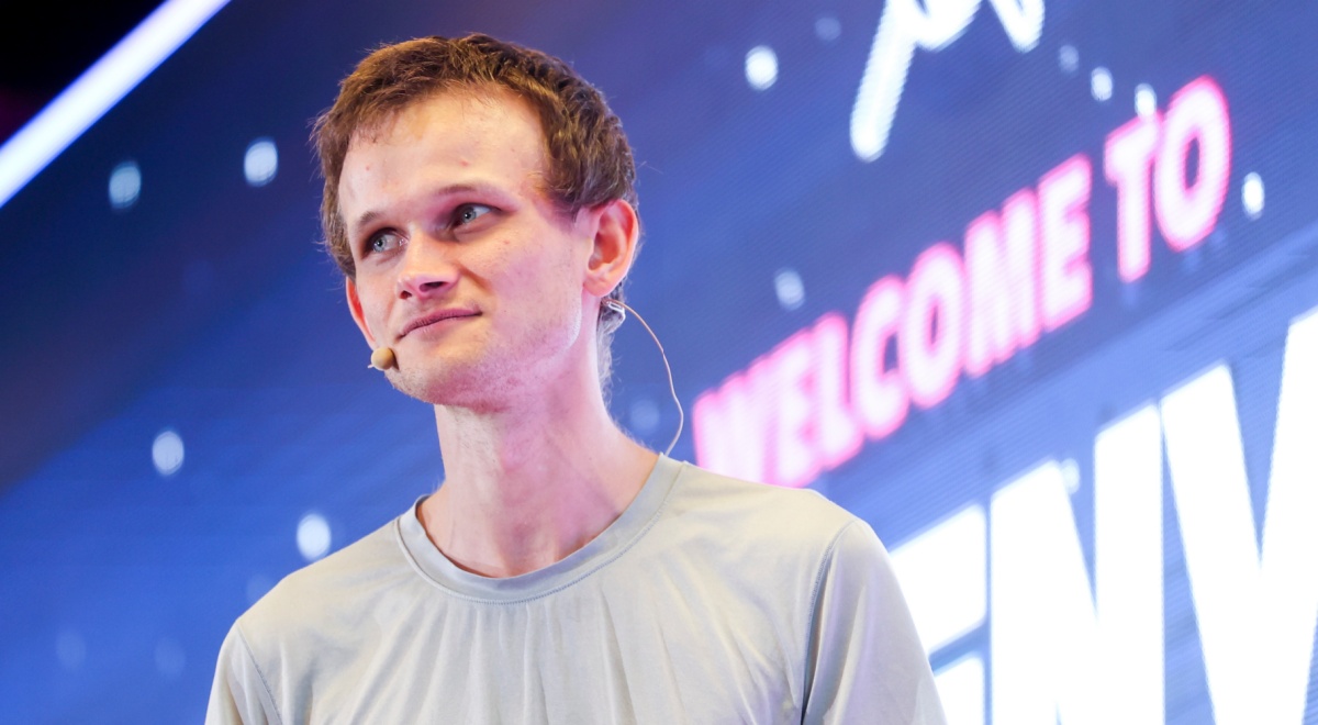 Vitalik Buterin, young pale white man, light brown gingerish hair, grey t-shirt, welcome to sign
