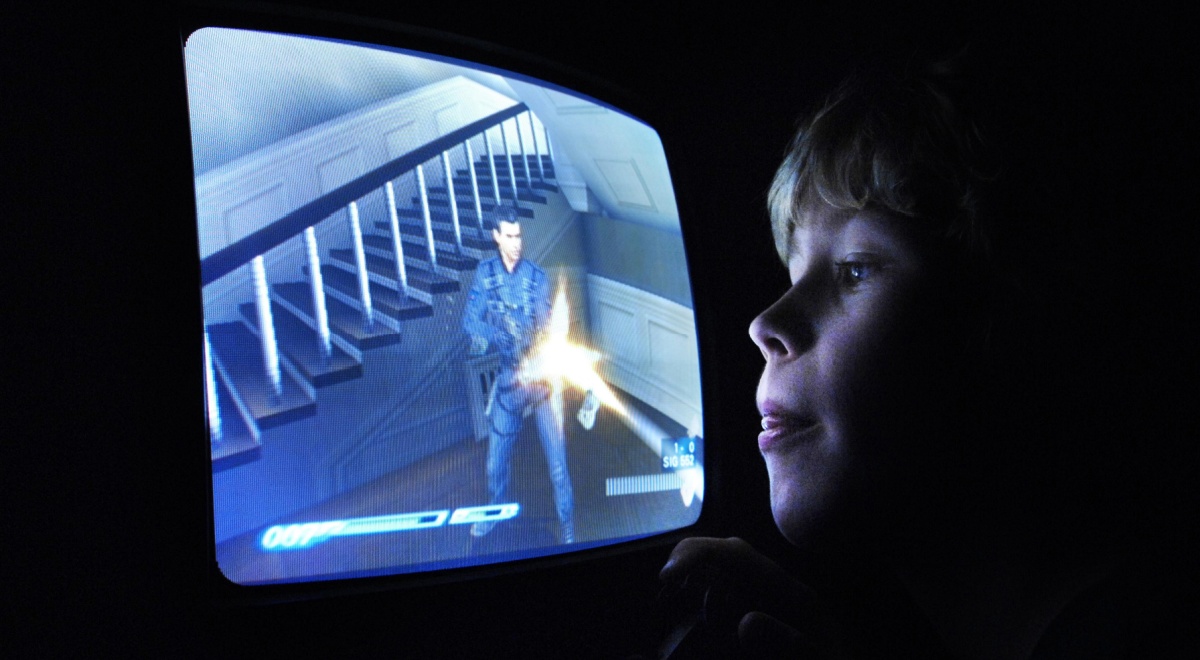 young blonde white boy, blue screen, shooter, yellow laser beam, staircase, old tv screen