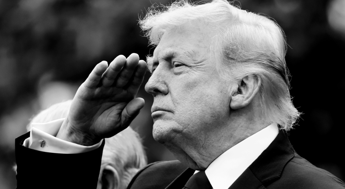 A black and white photo of President Trump saluting.
