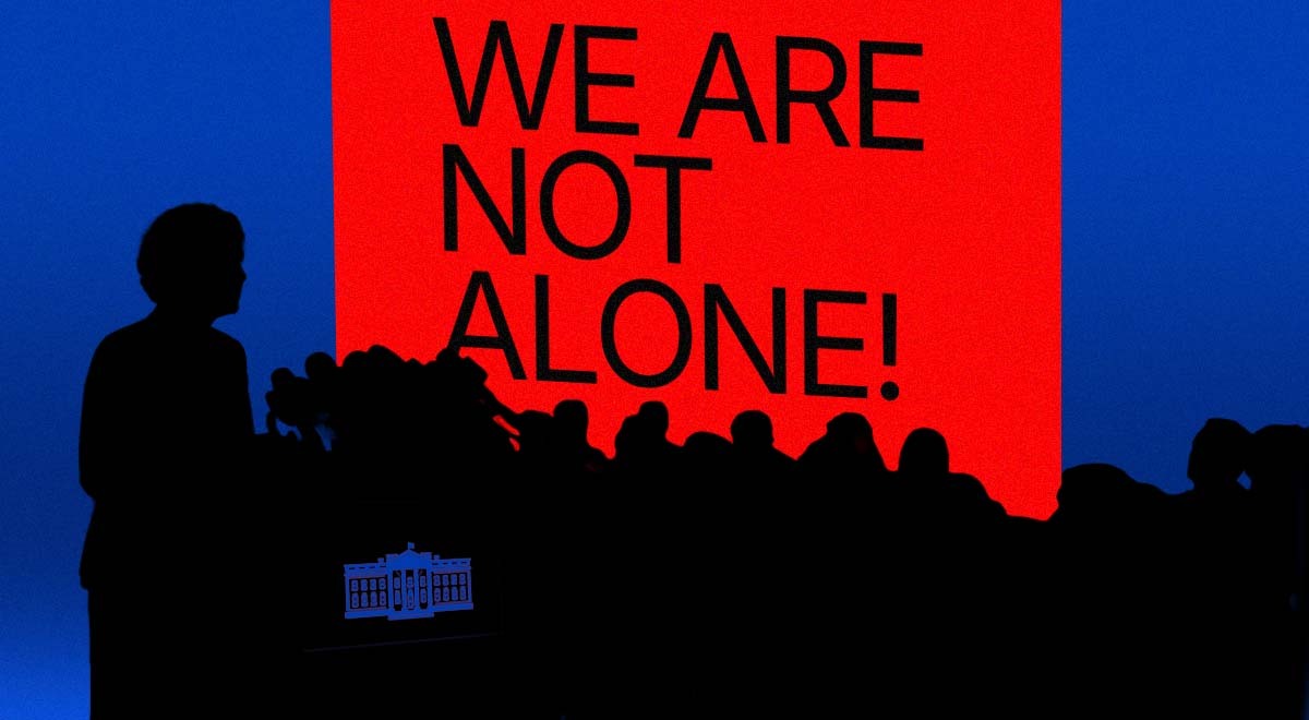 Silhouettes of journalists representing the White House with a "we are not alone" sign.