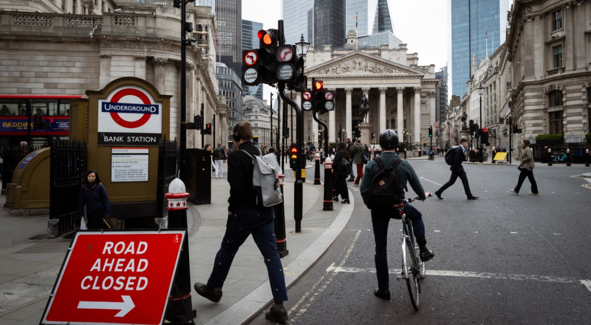 Bank of England building ,cyclist, red traffic sign,