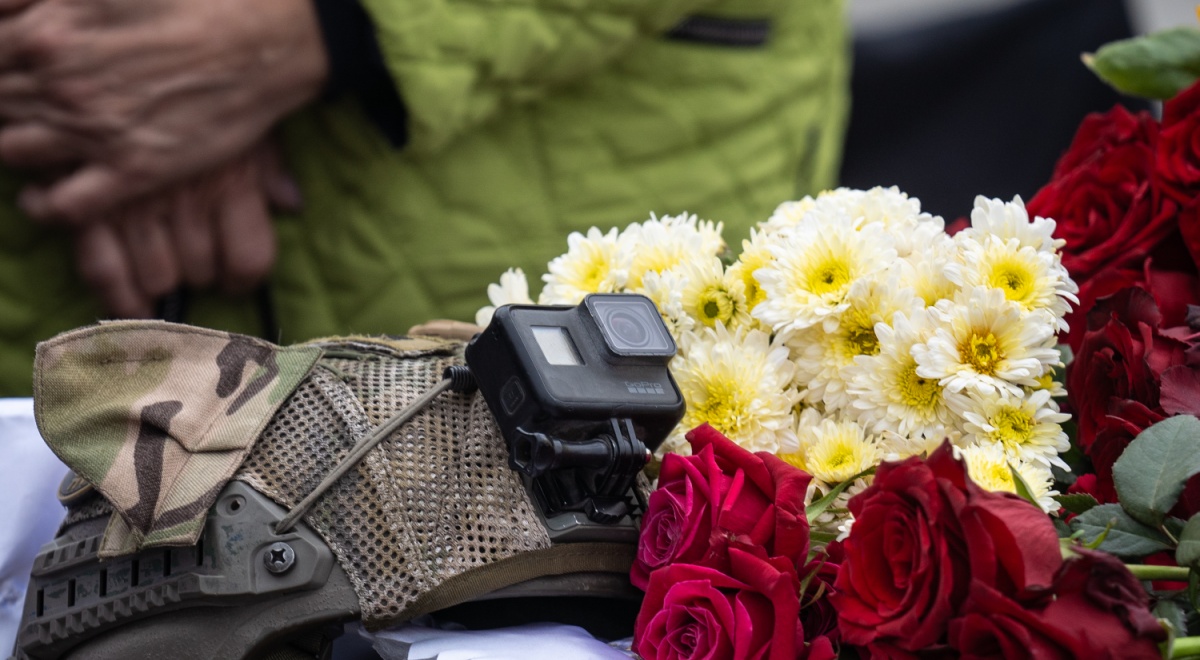black gopro camera, white flowers, red roses, dark green and brown army uniform