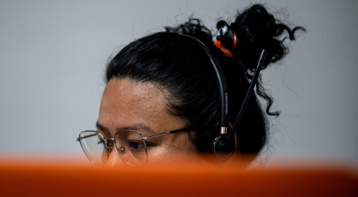 philippinese woman, black hear, messy bun, black headset ,dark skin, glasses, oily skin forehead