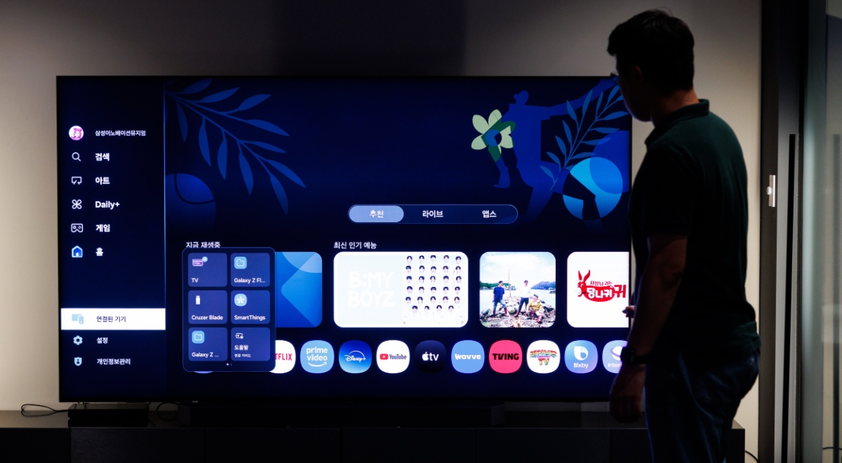 Samsung smart TV with a person in the background