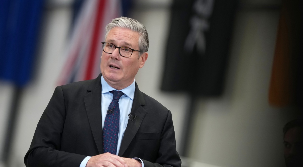 Britain's Prime Minister Keir Starmer, black suit, dark blue tie, white shirt, grey hair, glasses