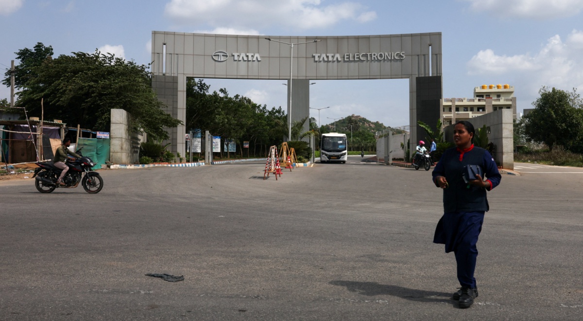tata electronics cement gate, entrance, indian woman, blue sky, white clouds,