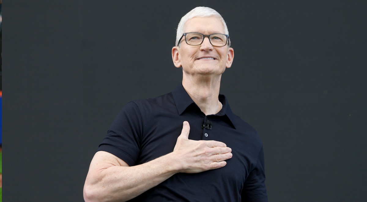 Apple CEO Tim Cook, right hand on heart, white male, grey white hair, left hand on heart