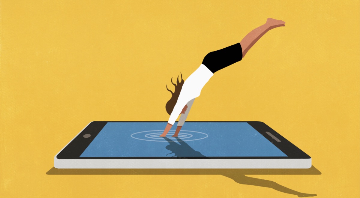 White woman diving into large digital tablet against yellow background, black shorts, white top