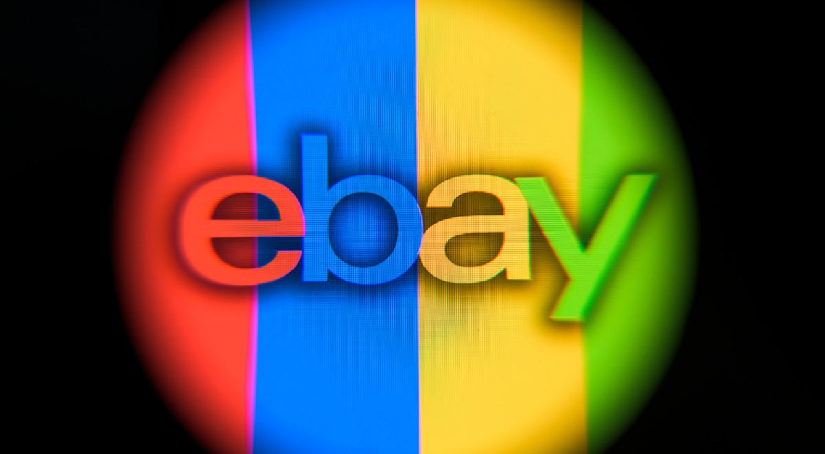ebay logo in round shape that's in red, blue, yellow, green stripes, black background