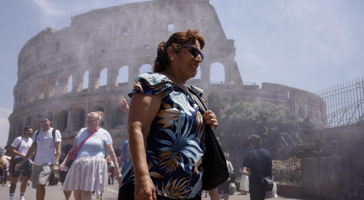 heat wave, elderly white tanned woman, rome's colosseum, sprinkles of water in the air, blue sky