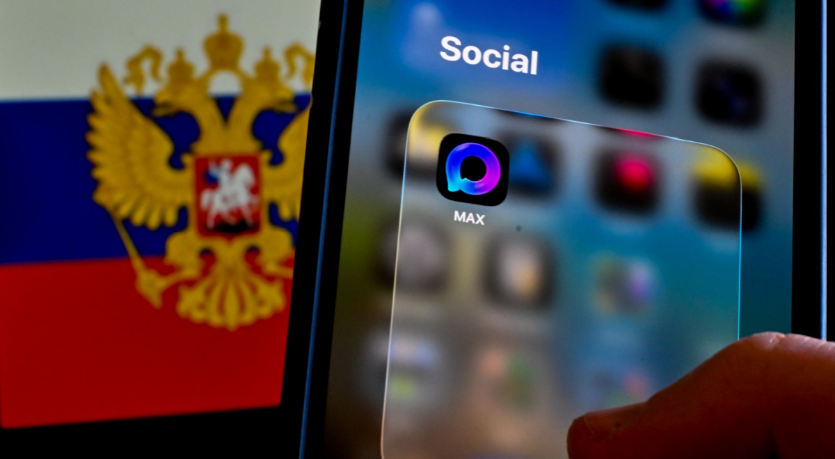 max app  icon on a smartphone, russia flag with eagles, coat of arms, in the background