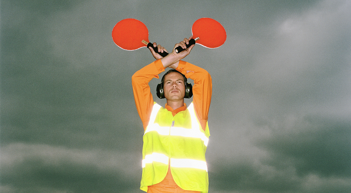 An air traffic controller holding light signals up in the air
