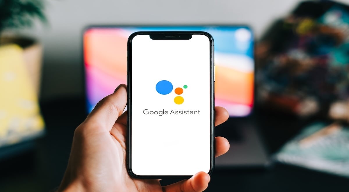 Hand holding phone with Google Assistant