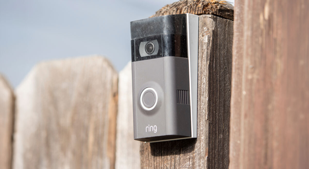 a Ring security camera fixed onto a fence