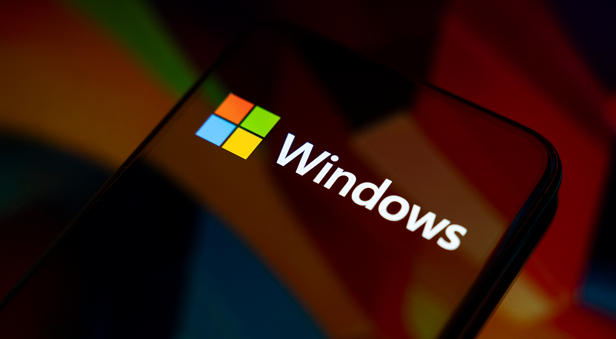 The Windows logo appears on the screen of a smartphone