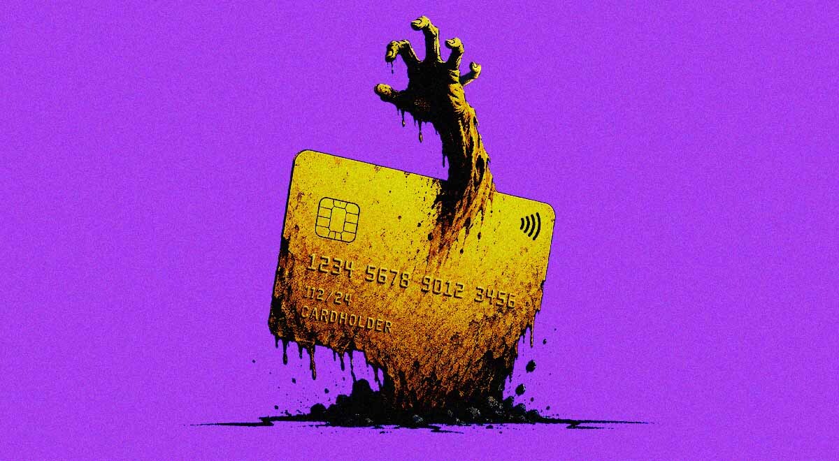 An expired credit card with a zombie-like hand reaching through it