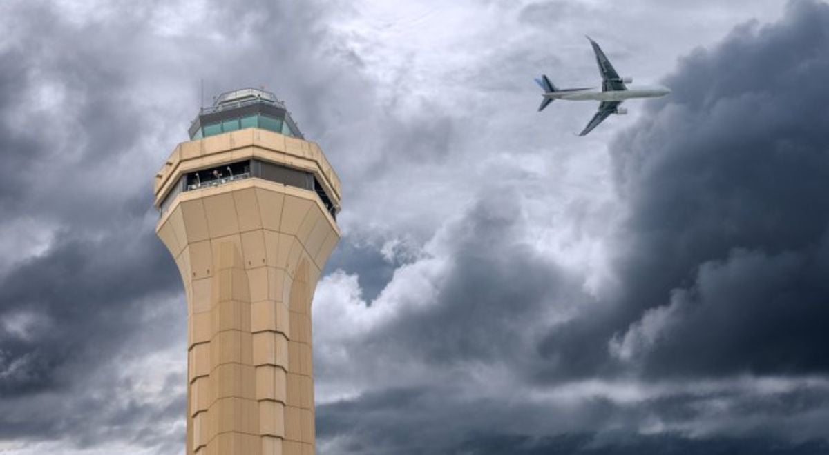 FAA air control tower and plae in background