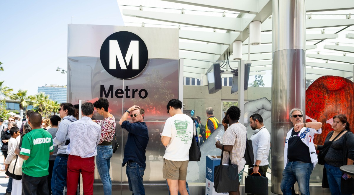 People standing next to LA Metro
