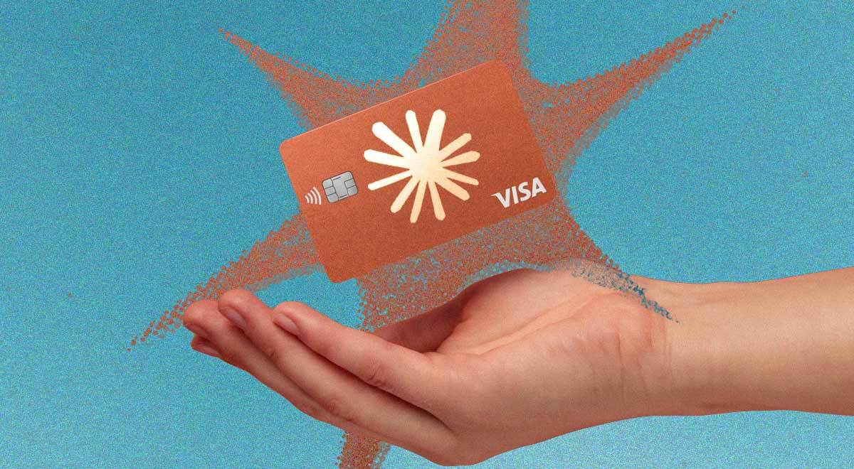 A hand holding a Visa card with Anthropic logo on it