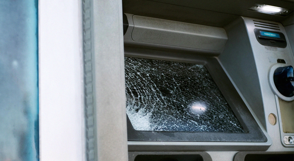 Broken glass ATM on street