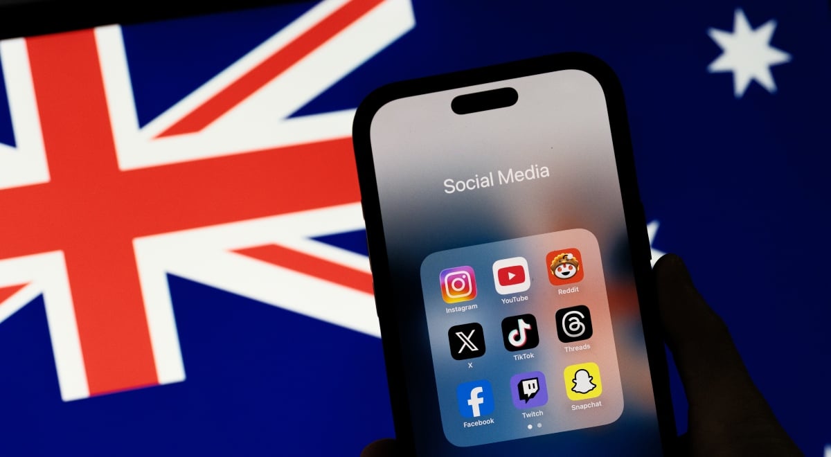 Logos of various social media apps on a phone screen next to Australian flag.