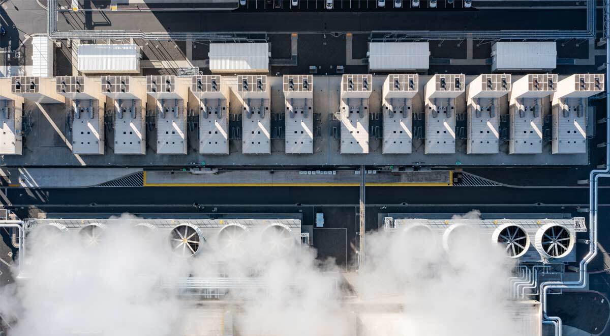Aerial drone view of a large hyperscale data center cooling system with massive industrial fans