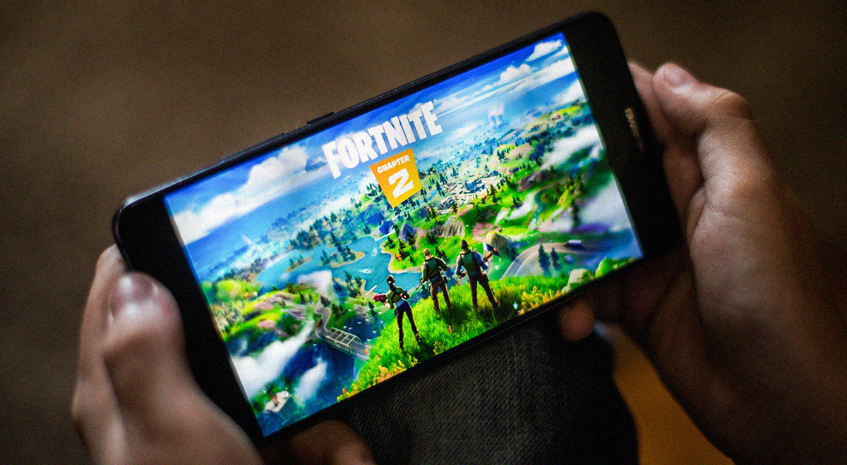 Device with Fortnite logo held with two hands